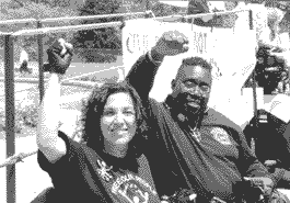 photo of two activists, grinning hugely